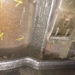 Multi-pass Flux-Cored (FCAW) weld on heavy steel fabrication for industrial applications.