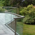 Curved stainless steel and glass balustrade corner for a residential property in Scotland.