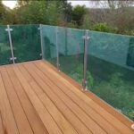 Custom stainless steel and glass balustrade installed on a residential decking in Scotland.