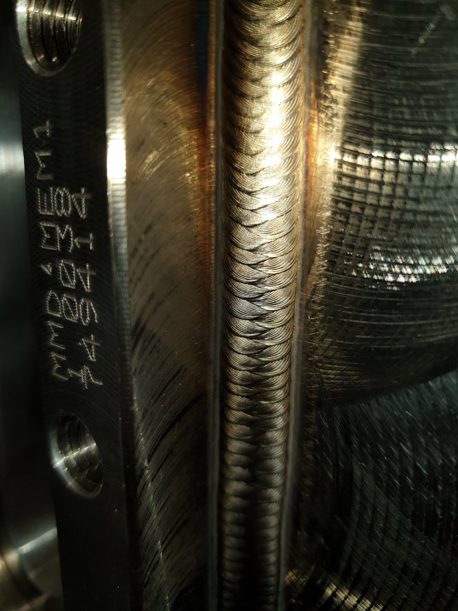 Close-up of a precision TIG weld on an industrial stainless steel component in Scotland.