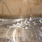 Multi-pass Flux-Cored (FCAW) fillet weld on heavy structural steel.